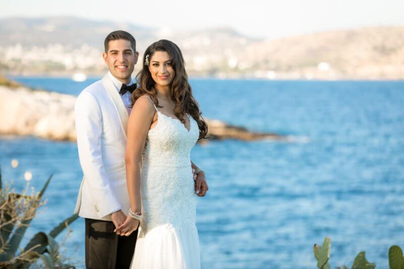 lovely couple posing during their wedding reception at Athenian Riviera